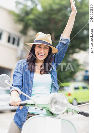 Portrait of woman riding with raised arm Portrait of woman riding with raised arm 24052839