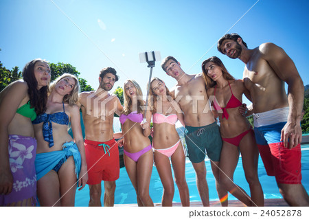 Happy friends in swimwear standing together Happy friends in swimwear standing together 24052878