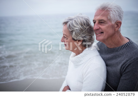 Senior couple embracing each other on the beach Senior couple embracing each other on the beach 24052879
