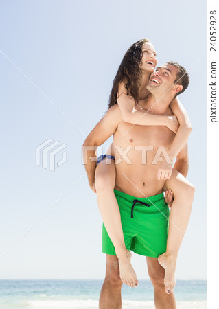 Boyfriend giving piggy back to girlfriend 24052928