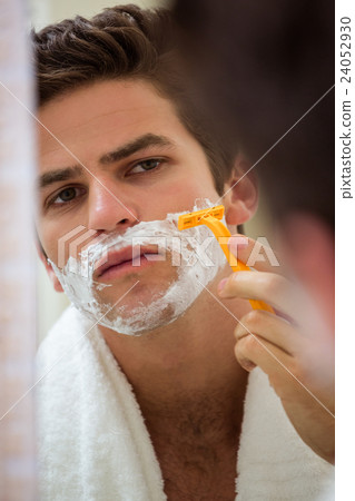 Reflection of young man shaving Reflection of young man shaving 24052930