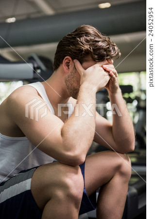 Tired man sitting on treadmill Tired man sitting on treadmill 24052954