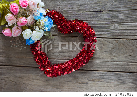 Tinsel heart decoration on wood background Tinsel heart decoration on wood background 24053032