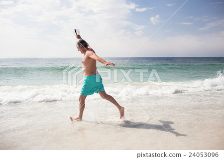 Senior man dancing on beach 24053096