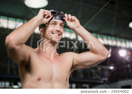 Swimmer wearing swimming goggles and cap 24054002