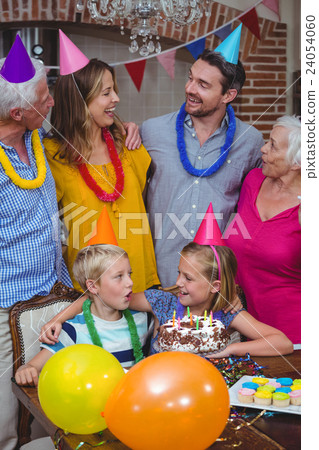 Smiling multi generation family celebrating birthday Smiling multi generation family celebrating birthday 24054060