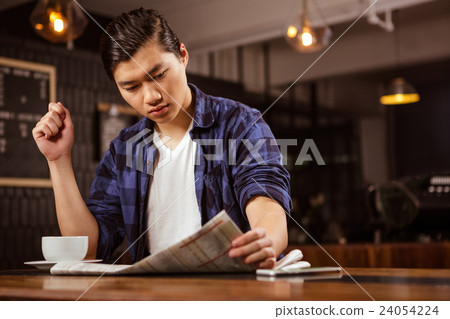 Hipster man reading newspaper Hipster man reading newspaper 24054224