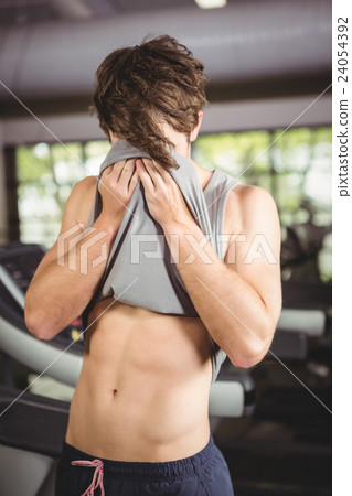 Tired man wiping his face after workout 24054392