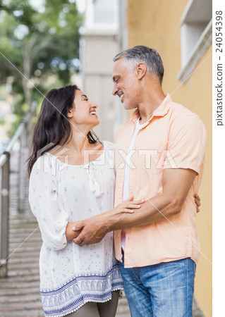 Cheerful couple looking each other Cheerful couple looking each other 24054398