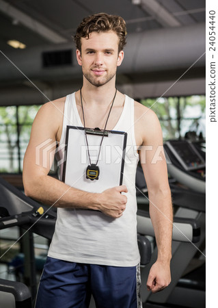 Gym instructor holding clipboard Gym instructor holding clipboard 24054440