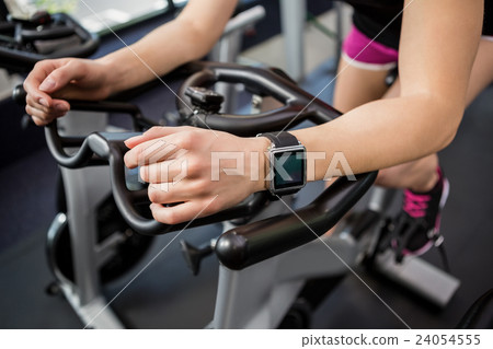 Woman working out on exercise bike 24054555