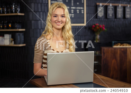 Smiling woman using laptop Smiling woman using laptop 24054910