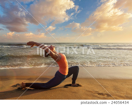 Sporty fit woman practices yoga Anjaneyasana at 24056434