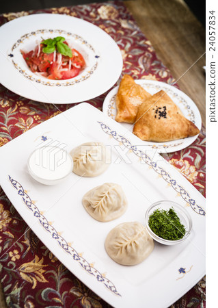 Manti, samosa and tomato salad Manti, samosa and tomato salad 24057834