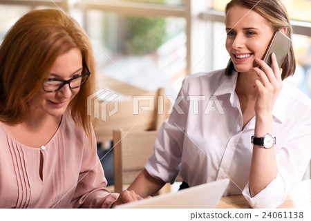 Cheerful woman talking on smart phone Cheerful woman talking on smart phone 24061138