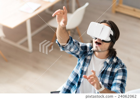 Positive man using virtual reality device 24062062