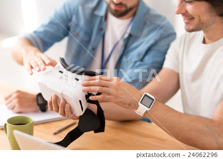 Pleasant colleagues working on virtual reality Pleasant colleagues working on virtual reality 24062296