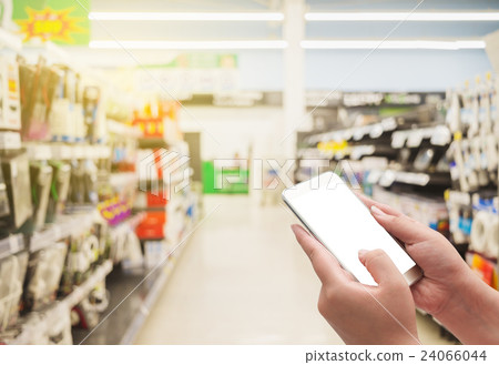 Hand with smart phone on shopping mall 24066044