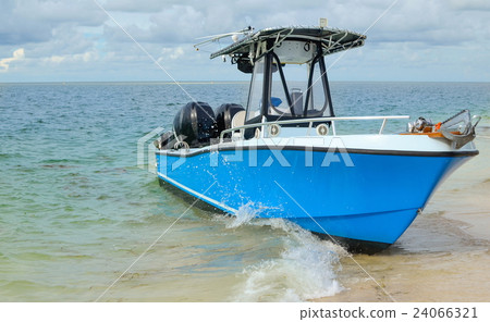 Small boat on a wavy blue sea Small boat on a wavy blue sea 24066321