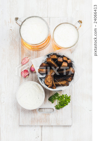 Beer snack set. Two mugs of pilsener, rye bread Beer snack set. Two mugs of pilsener, rye bread 24066413