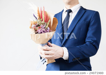 Young man in fashionable suit holding bouquet Young man in fashionable suit holding bouquet 24071980