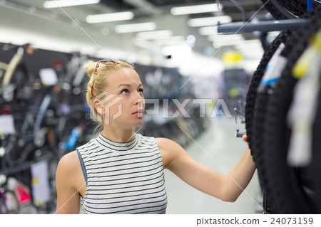 Woman shopping sports equipment in sportswear 24073159