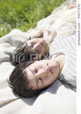 A couple sleeping in the meadow A couple sleeping in the meadow 24073192