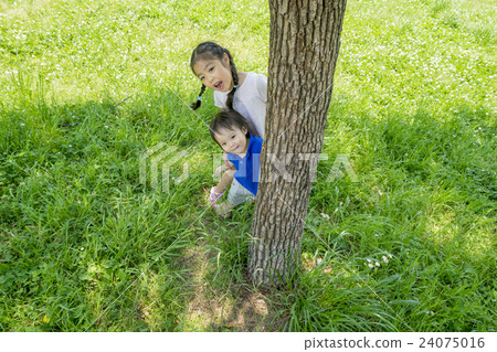 My older sister and brother playing in the shade of the park My older sister and brother playing in the shade of the park 24075016