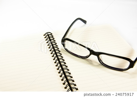 Open notebook with glasses 24075917