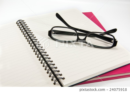 Glasses on a pink notebook 24075918