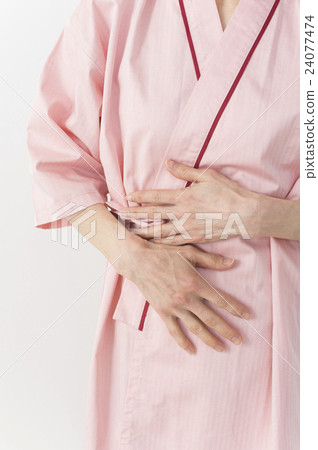A middle woman who holds her stomach by wearing a test 24077474