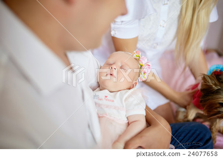 Babygirl sleeps on father's arms 24077658