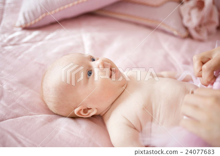 Little blue-eyed girl laugh while lying  24077683