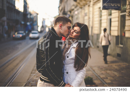 Handsome man in sport jacket kisses a lady Handsome man in sport jacket kisses a lady 24078490
