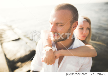 Wedding couple kissing and hugging on rocks near Wedding couple kissing and hugging on rocks near 24079672