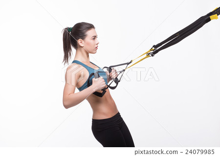 Woman training with suspension trainer sling 24079985