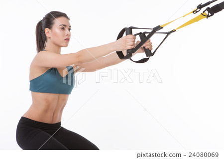 Woman training with suspension trainer sling 24080069