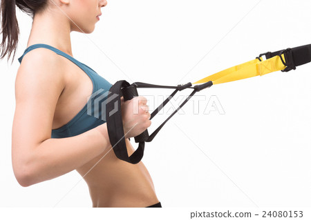 Woman training with suspension trainer sling Woman training with suspension trainer sling 24080153