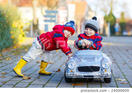 Two little kids boys playing with toy car Two little kids boys playing with toy car 24080609