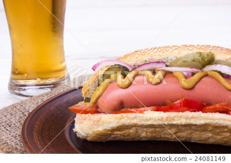 hot dog with a glass of beer on a white table hot dog with a glass of beer on a white table 24081149