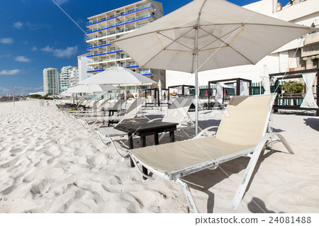 Vacation on beach with sun umbrellas and beds Vacation on beach with sun umbrellas and beds 24081488
