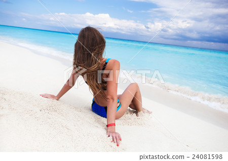 Woman on sandy beach enjoying tropical holidays 24081598