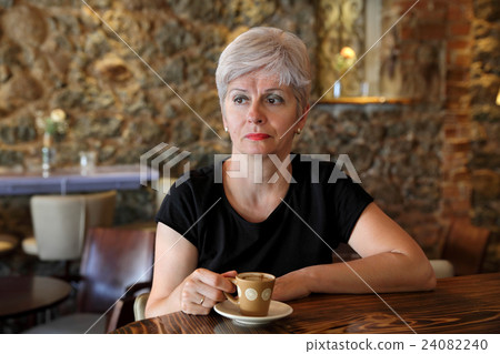 Woman in cafe drinking coffee Woman in cafe drinking coffee 24082240