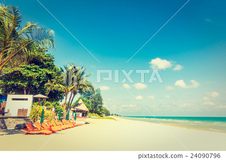 Umbrella and chair on the beach Umbrella and chair on the beach 24090796
