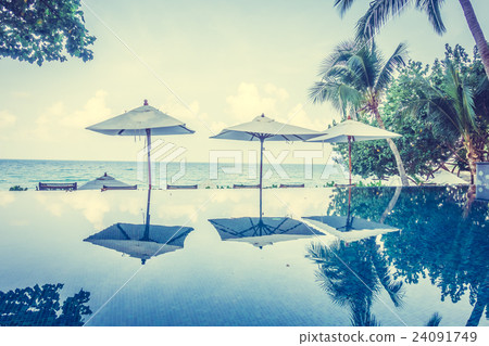 Umbrella pool and chair Umbrella pool and chair 24091749