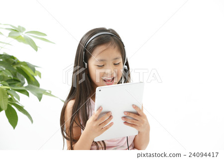A girl studying on a tablet A girl studying on a tablet 24094417