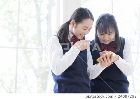 Female students watching smartphones 24097282