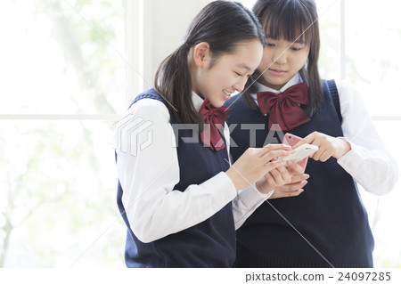 Female students watching smartphones 24097285