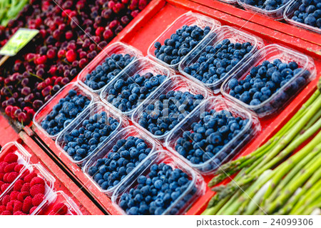 Blueberry in plastic boxes lies  24099306