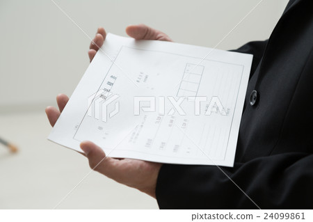 A man wearing a suit with an estimate A man wearing a suit with an estimate 24099861